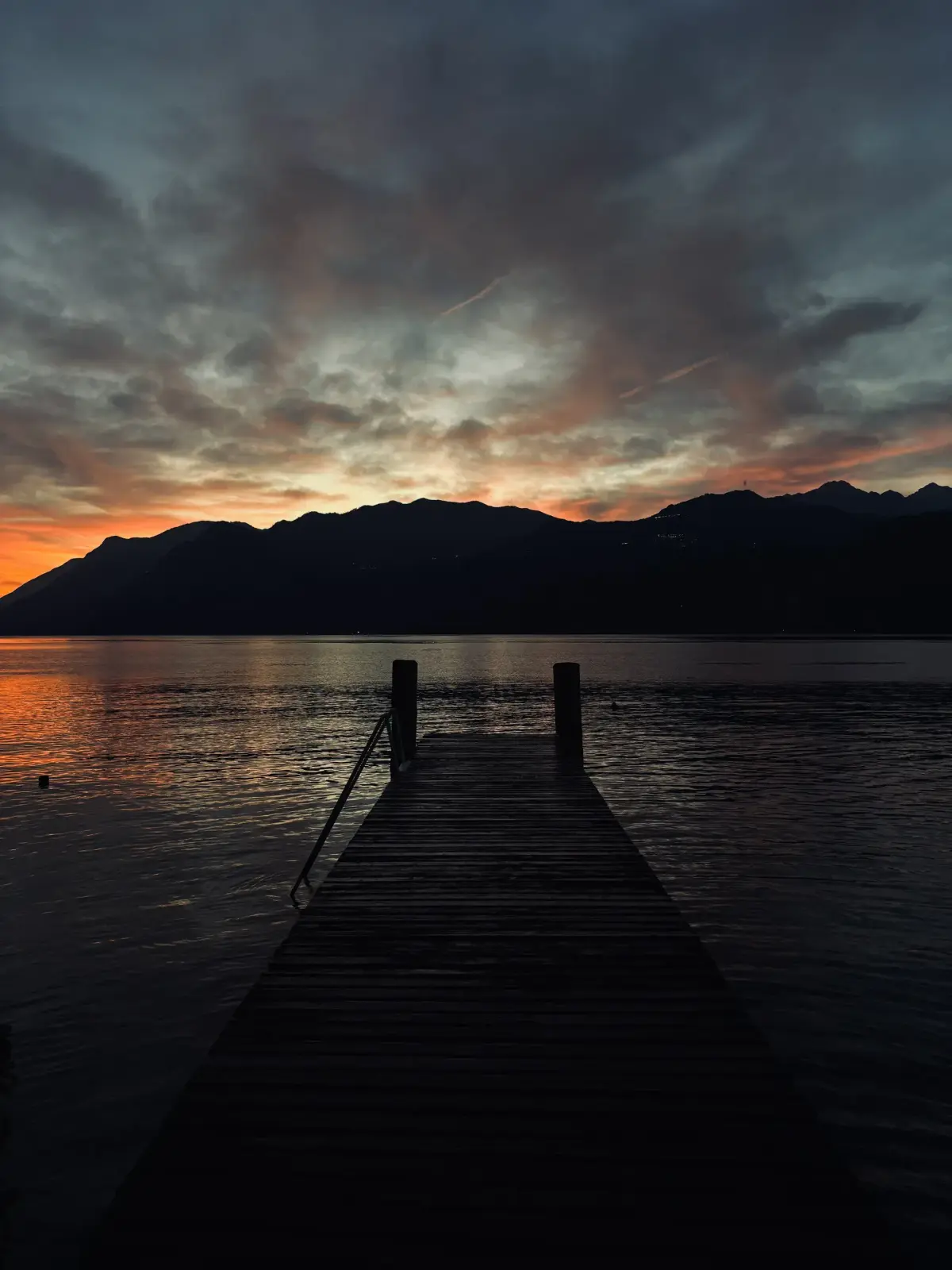 Pontile del lido al tramonto verso le montagne del Lago di Garda